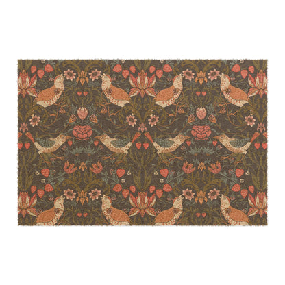 A rectangular coconut coir doormat with a floral pattern featuring birds and strawberries, predominantly in brown and green shades.