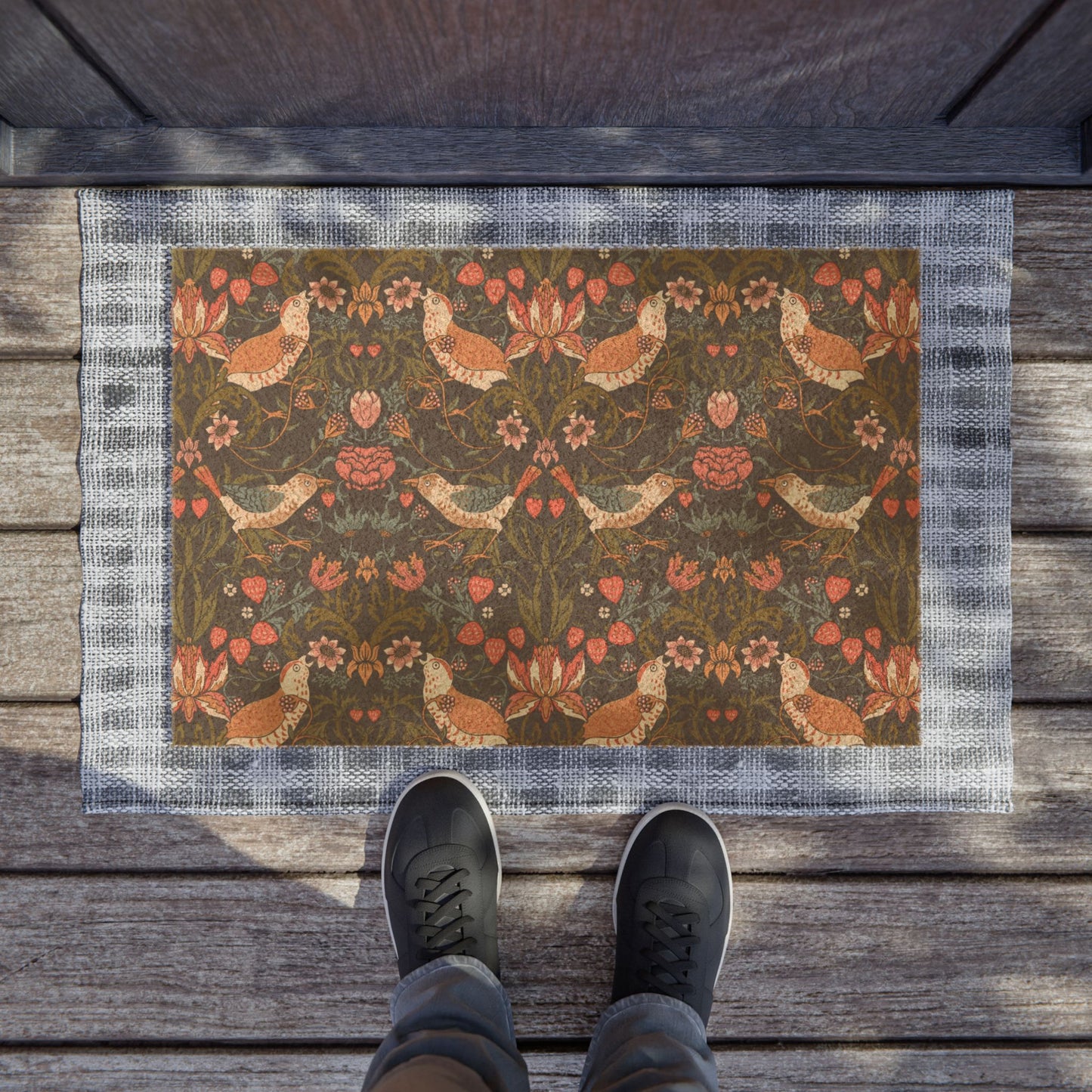 Decorative doormat with floral and chicken pattern on wooden floor.