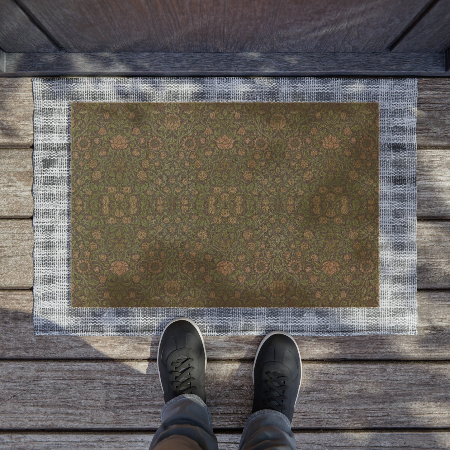 A rectangular green coconut coir doormat with an intricate geometric floral William Morris & Co pattern and a black vinyl backing, designed for outdoor use.
