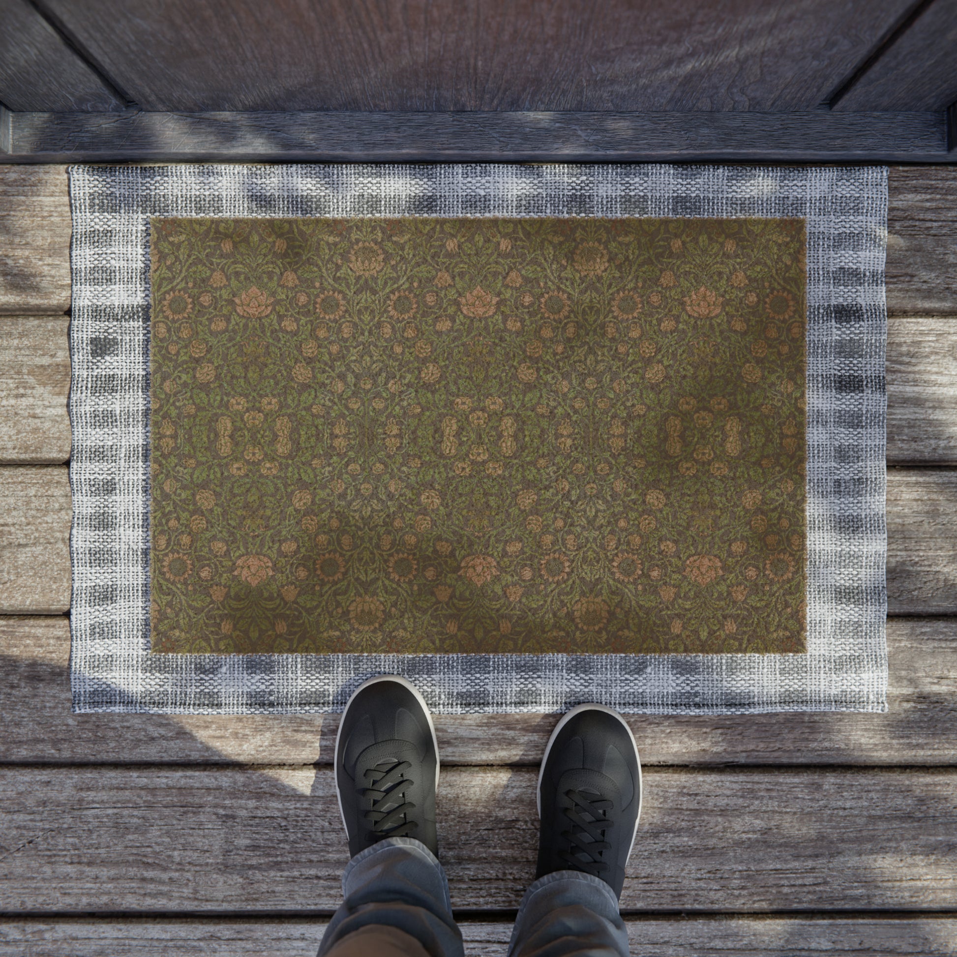 A rectangular green coconut coir doormat with an intricate geometric floral William Morris & Co pattern and a black vinyl backing, designed for outdoor use.
