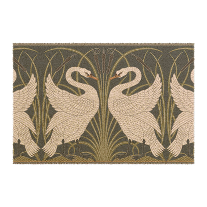 A rectangular doormat featuring a design of two white swans with a green and gold floral background, on a spruce green background.