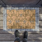 A rectangular coconut coir doormat with a floral pattern inspired by William Morris, featuring shades of blue, beige, and brown.