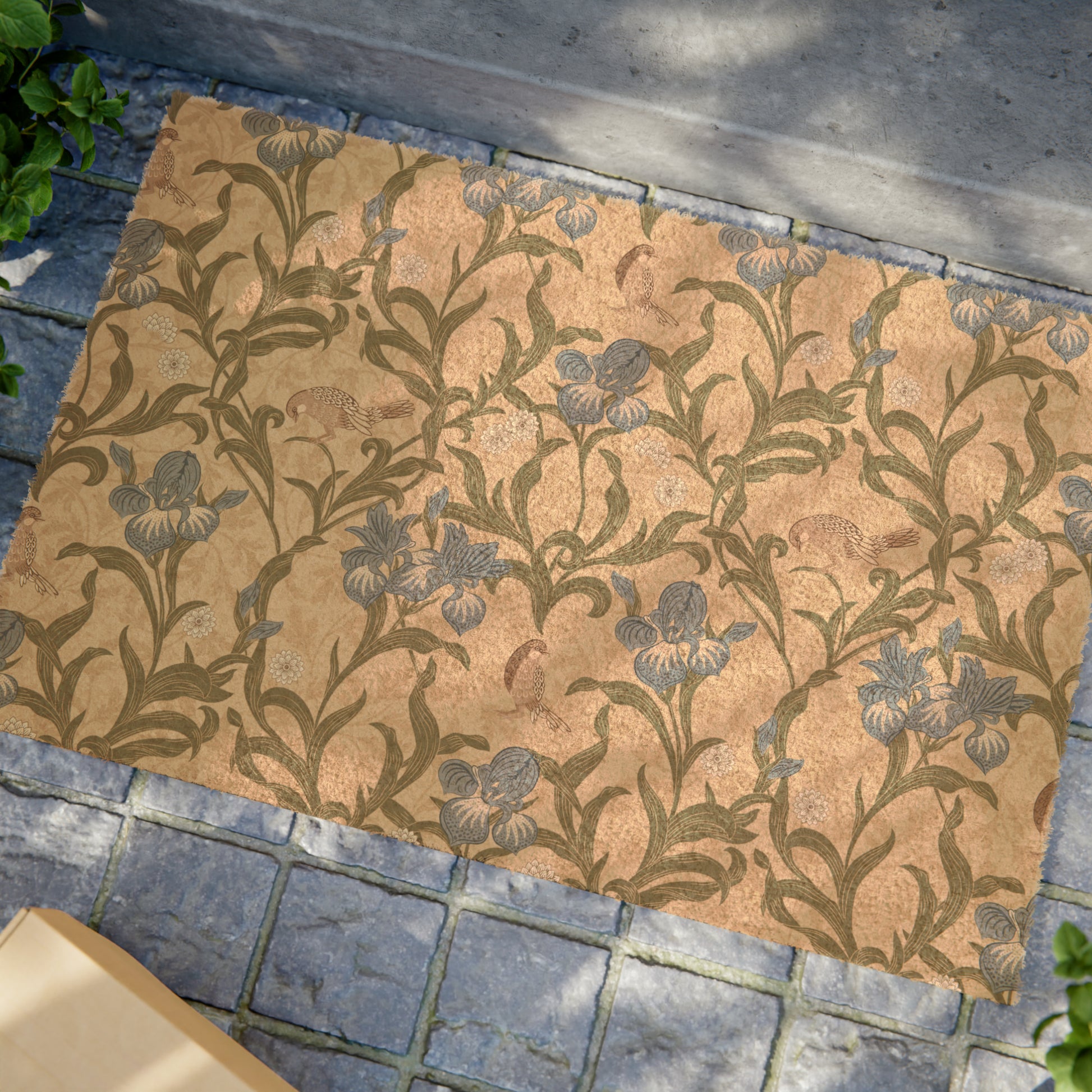 A rectangular coconut coir doormat with a floral pattern inspired by William Morris, featuring shades of blue, beige, and brown.