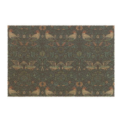 A rectangular coconut coir doormat with an intricate floral and animal pattern design, primarily in brown and green colours, with a black vinyl backing.