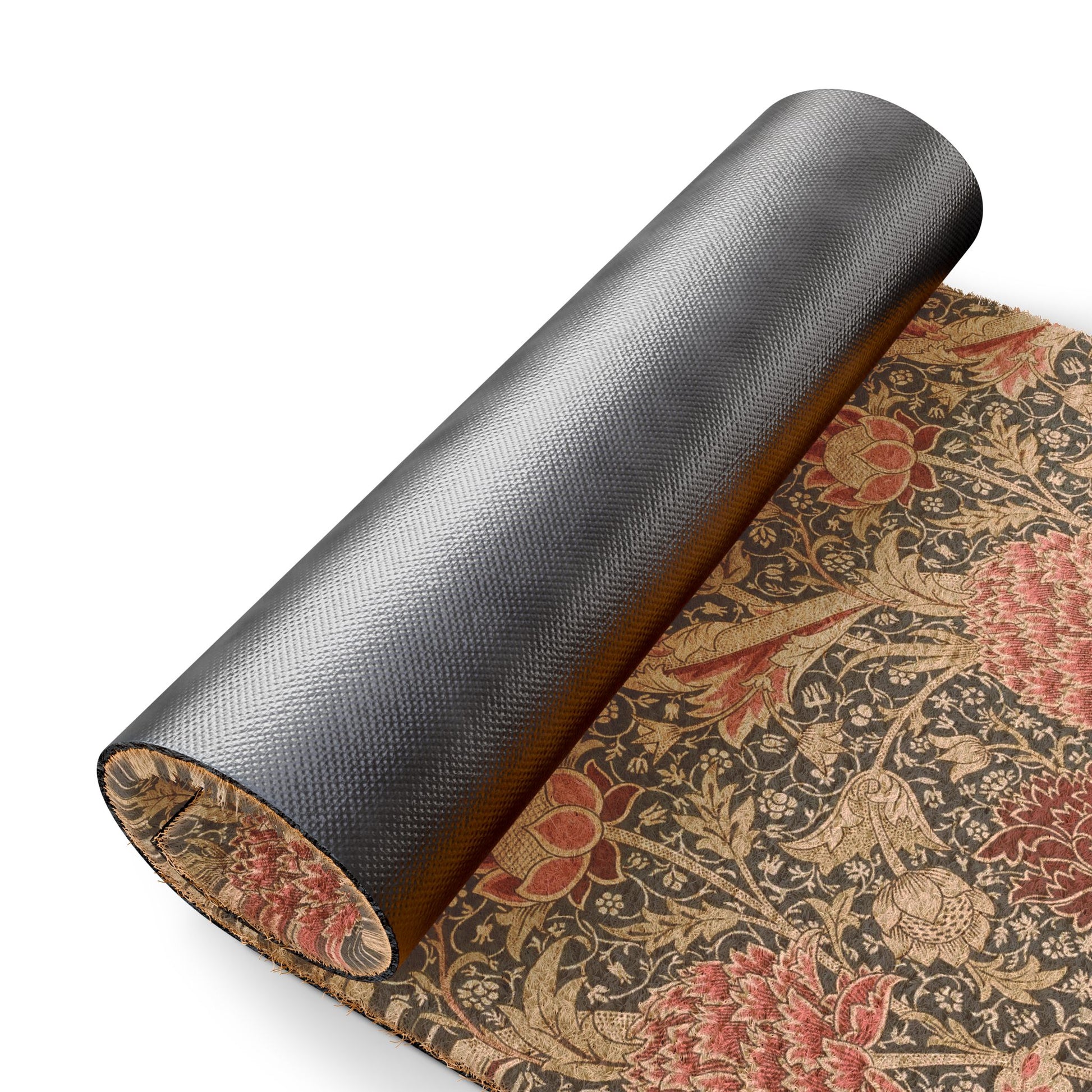 A rolled-up dark gray textured mat or rug shown on a white background, with part of the unrolled section revealing an ornate floral pattern in beige, red, and brown.