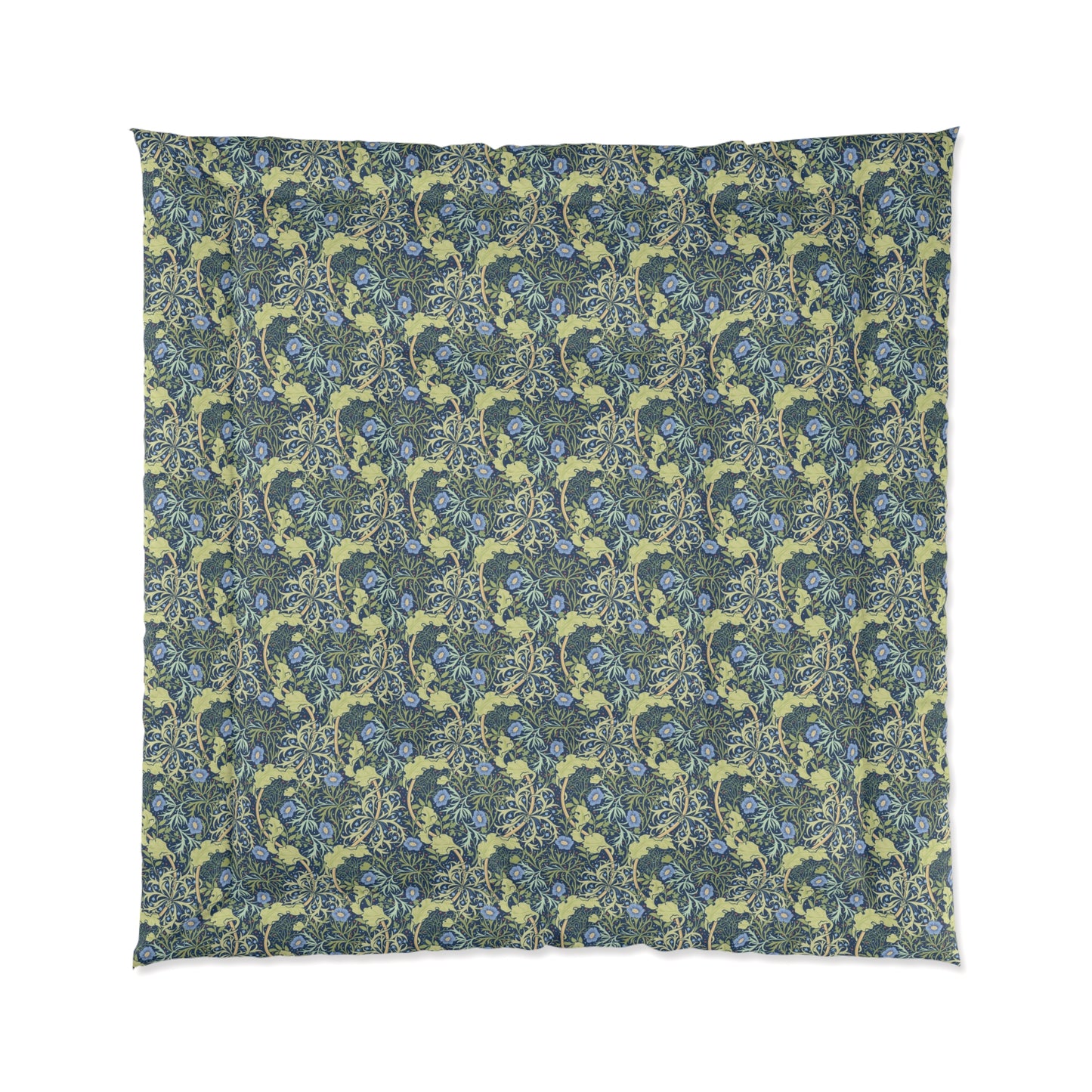 A folded comforter with a blue floral pattern inspired by William Morris's Seaweed Collection.