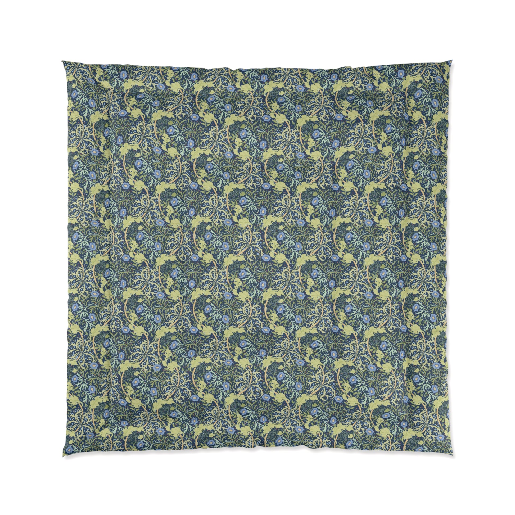 A folded comforter with a blue floral pattern inspired by William Morris's Seaweed Collection.