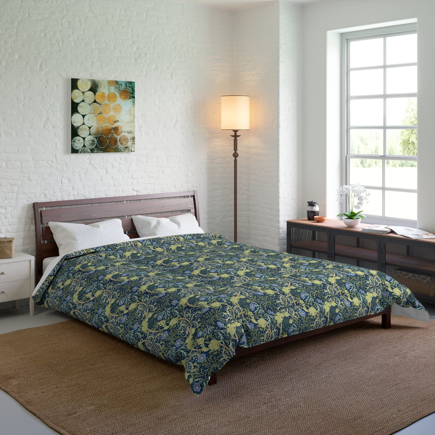 A folded comforter with a blue floral pattern inspired by William Morris's Seaweed Collection.