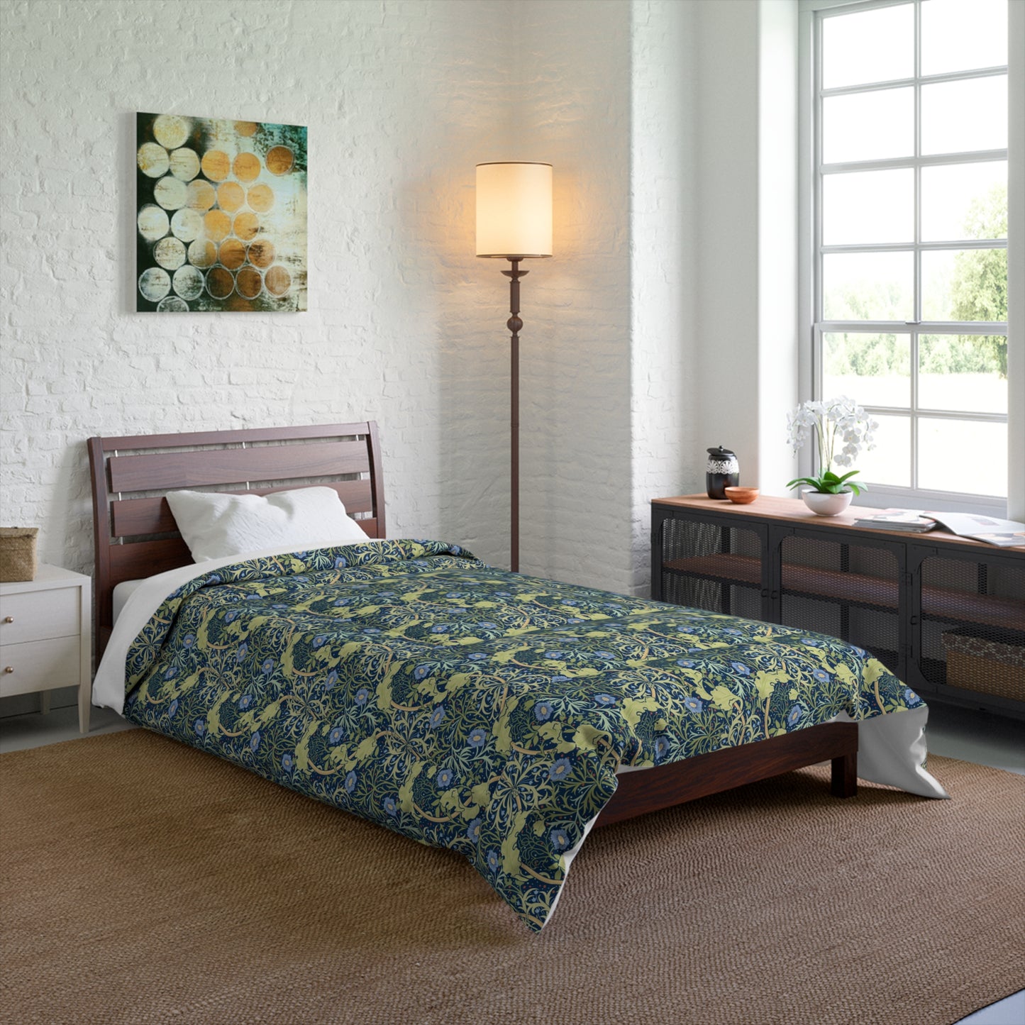 A folded comforter with a blue floral pattern inspired by William Morris's Seaweed Collection.