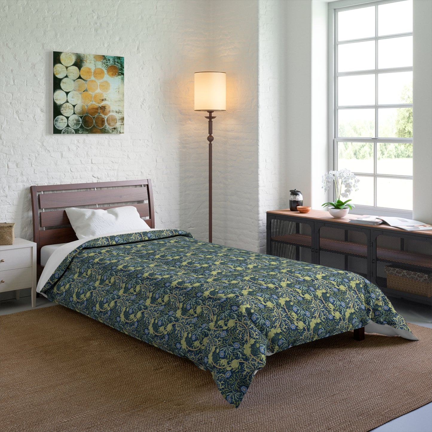 A folded comforter with a blue floral pattern inspired by William Morris's Seaweed Collection.