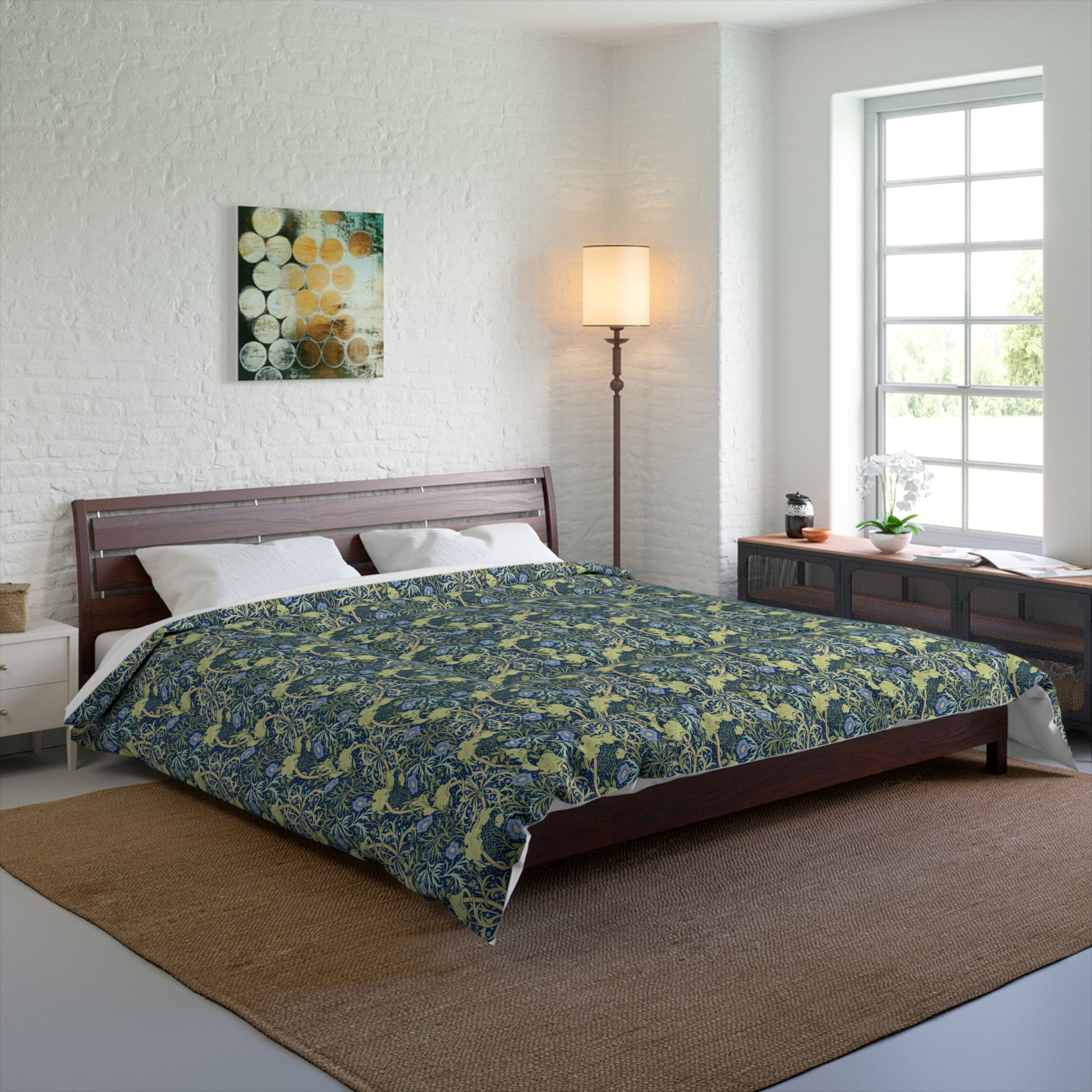 A folded comforter with a blue floral pattern inspired by William Morris's Seaweed Collection.