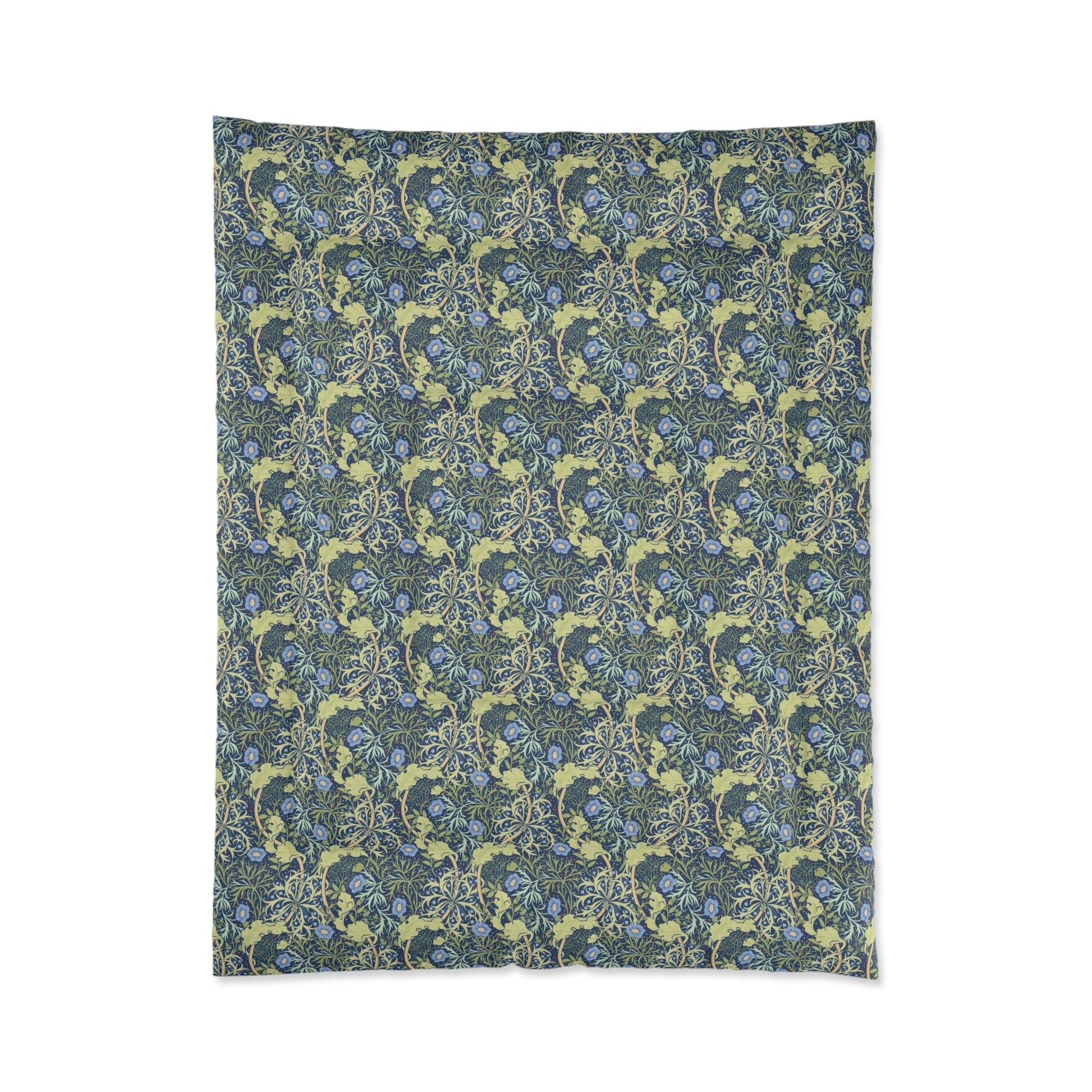 A folded comforter with a blue floral pattern inspired by William Morris's Seaweed Collection.