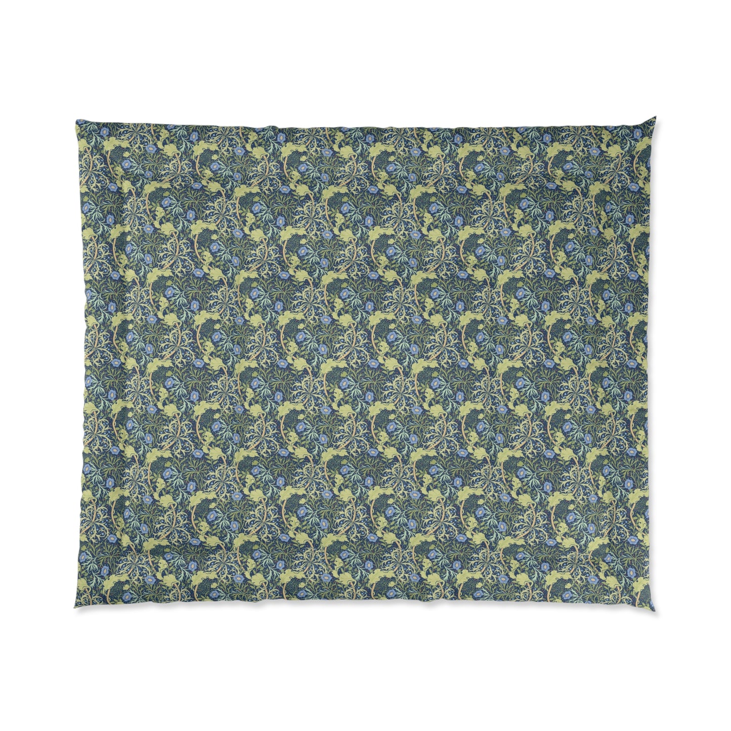 A folded comforter with a blue floral pattern inspired by William Morris's Seaweed Collection.