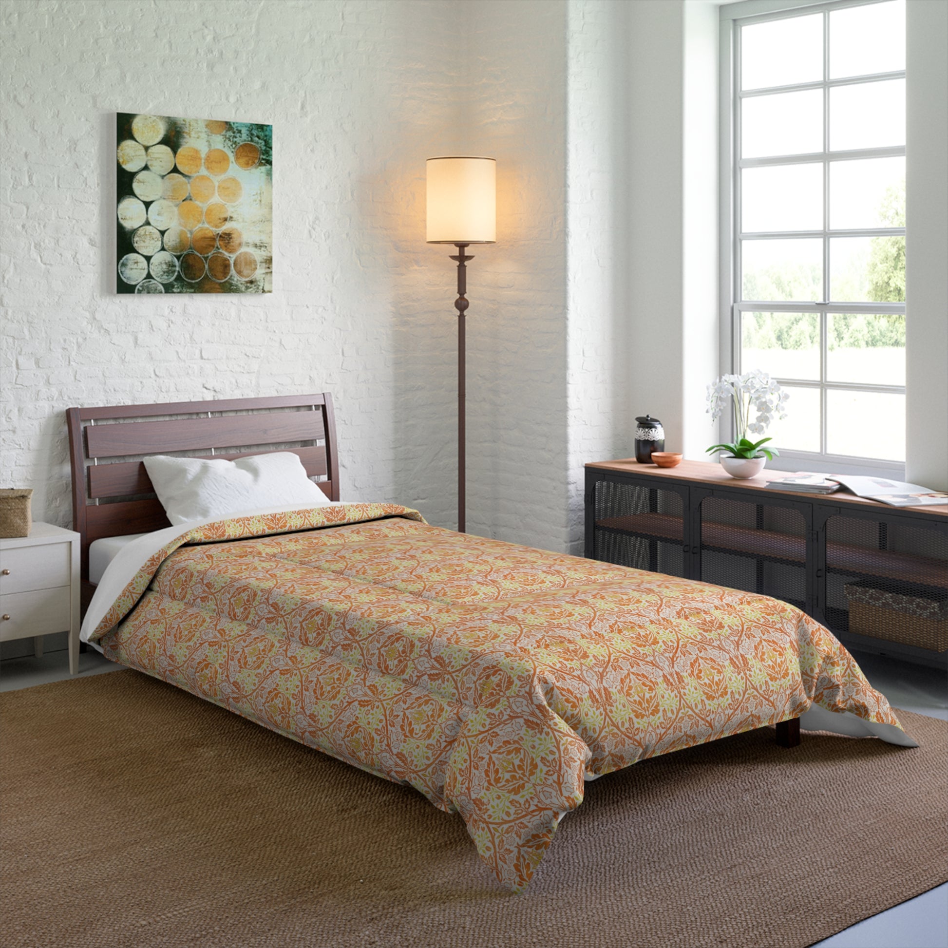A comforter with a geometric William Morris & Co pattern called Golden Bough in shades of yellow, white, and orange.