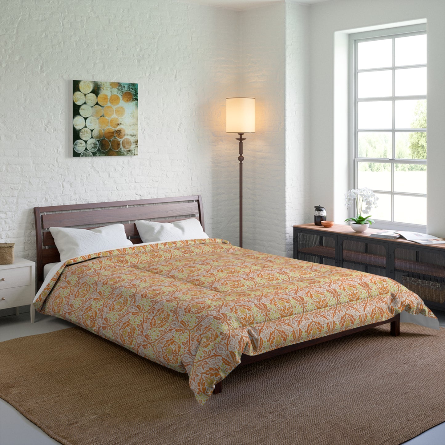 A comforter with a geometric William Morris & Co pattern called Golden Bough in shades of yellow, white, and orange.