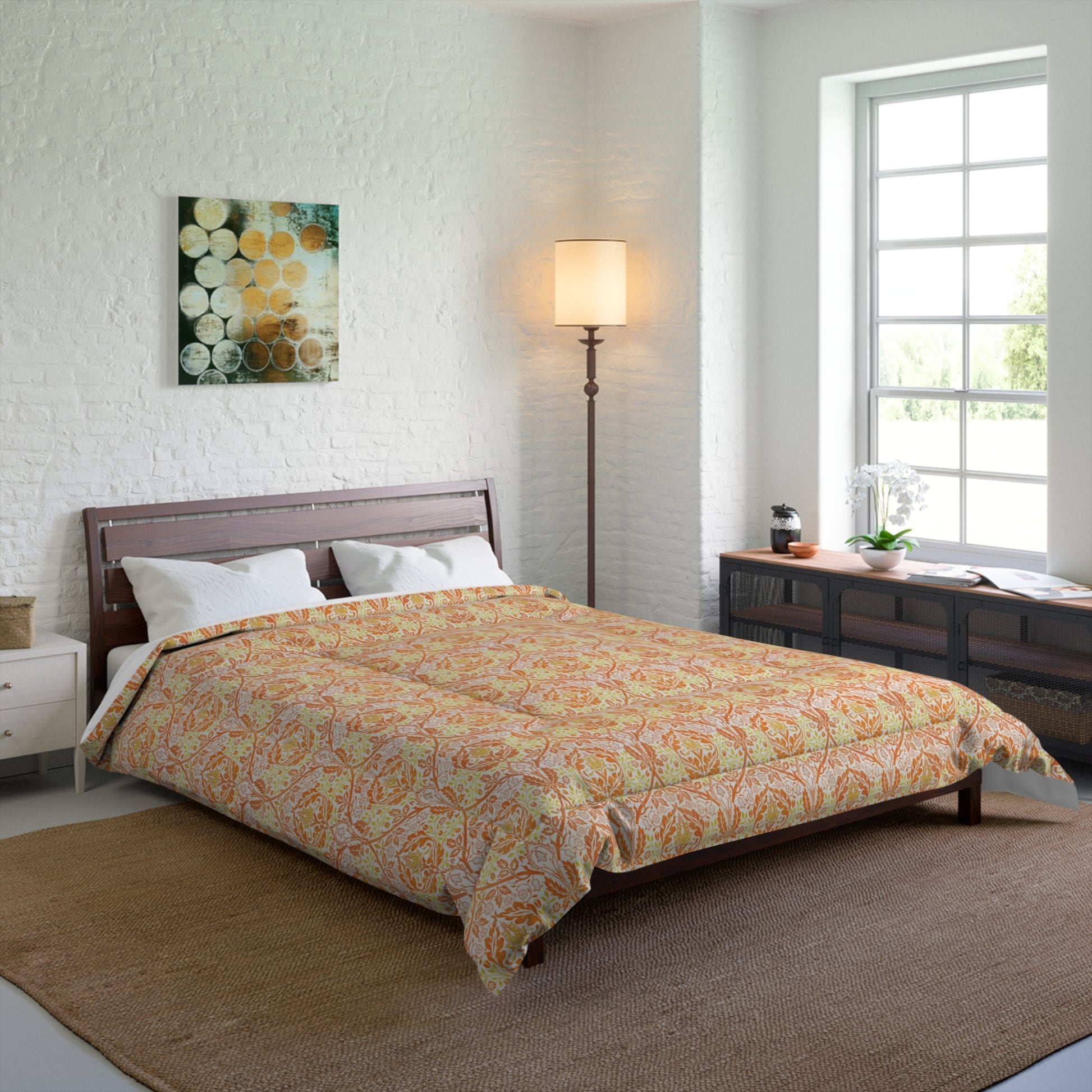 A comforter with a geometric William Morris & Co pattern called Golden Bough in shades of yellow, white, and orange.