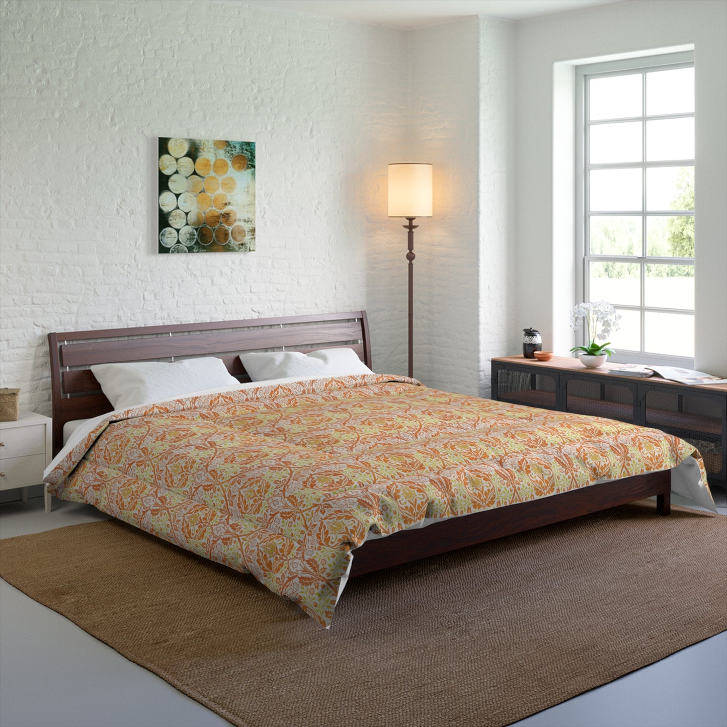 A comforter with a geometric William Morris & Co pattern called Golden Bough in shades of yellow, white, and orange.