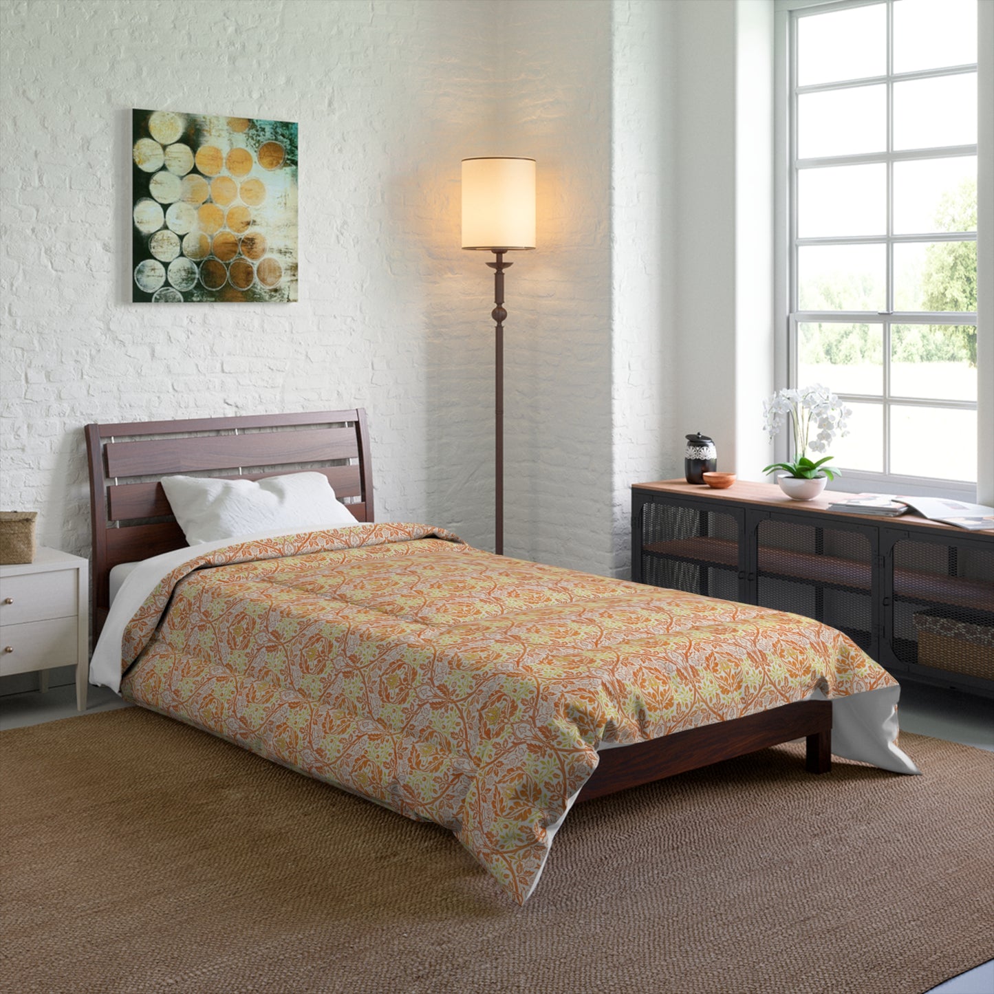 A comforter with a geometric William Morris & Co pattern called Golden Bough in shades of yellow, white, and orange.
