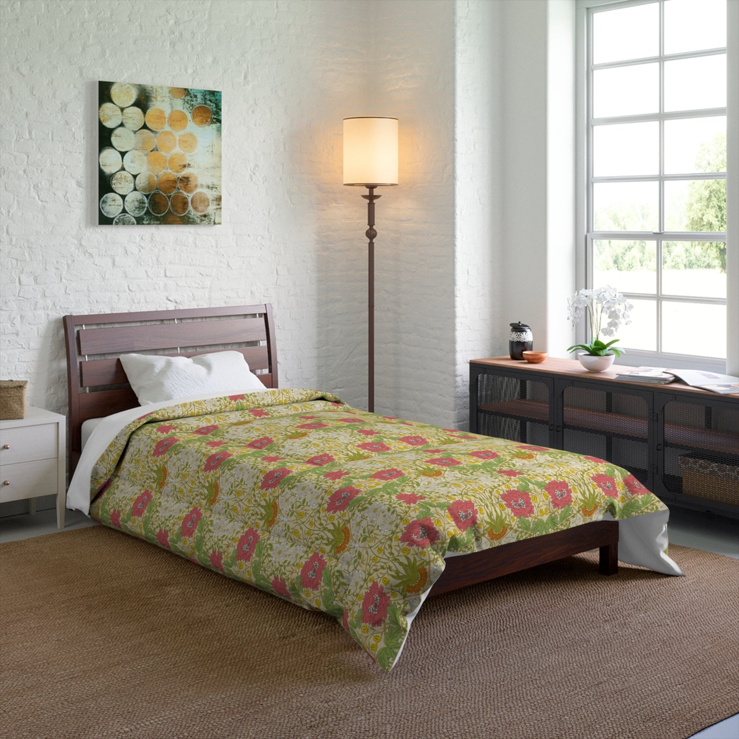 A bedspread comforter with a floral William Morris & Co pattern featuring honeysuckle flowers in shades of yellow, red and green on a white background.