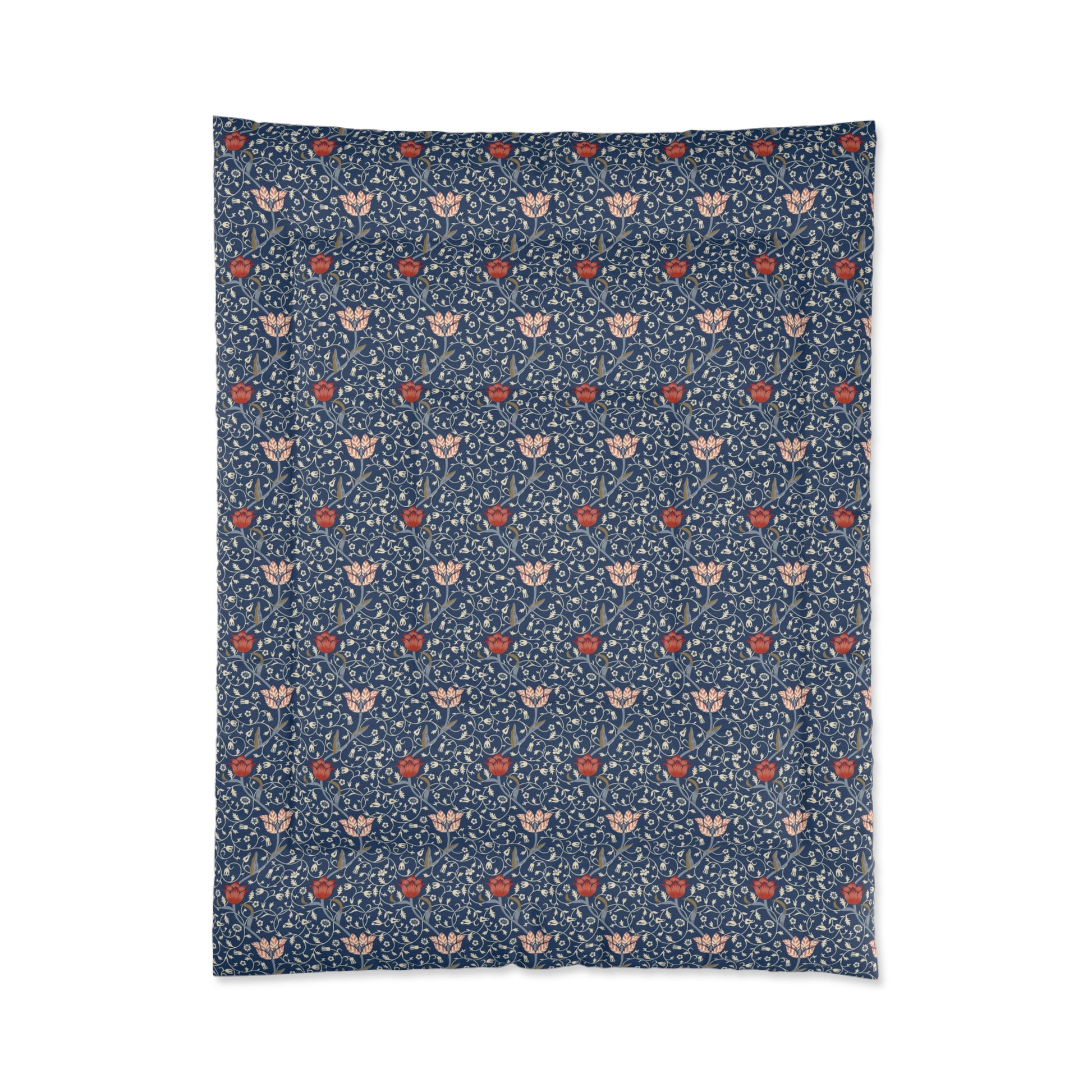 A square-shaped comforter with a blue background featuring a repeating William Morris & Co pattern of red and white apple designs and a plush batting layer visible on one side.
