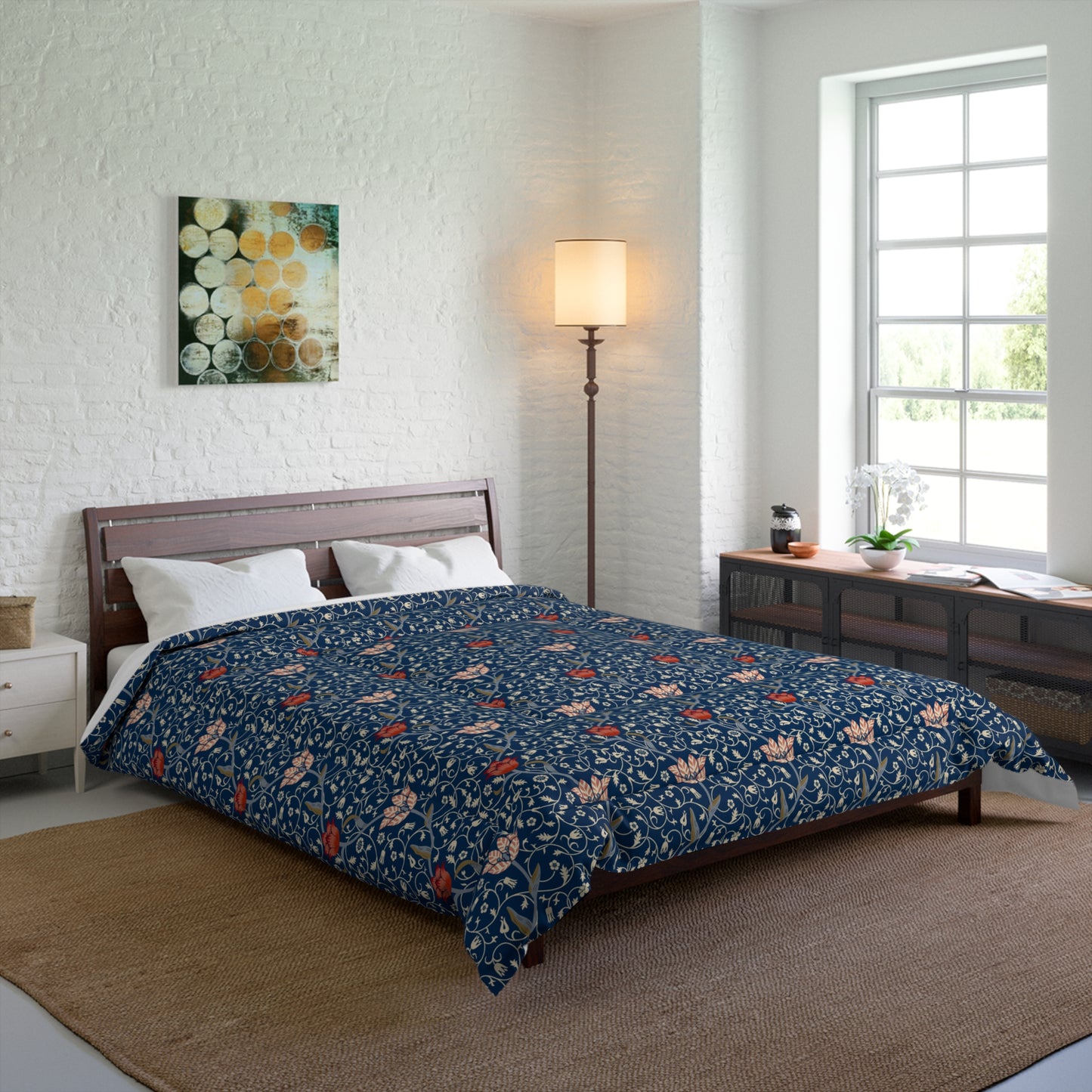 A square-shaped comforter with a blue background featuring a repeating William Morris & Co pattern of red and white apple designs and a plush batting layer visible on one side.