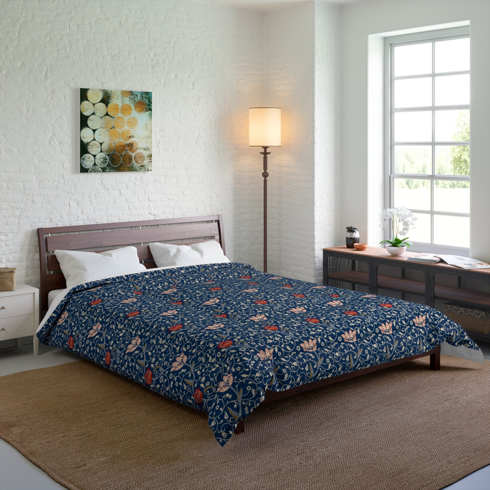 A square-shaped comforter with a blue background featuring a repeating William Morris & Co pattern of red and white apple designs and a plush batting layer visible on one side.
