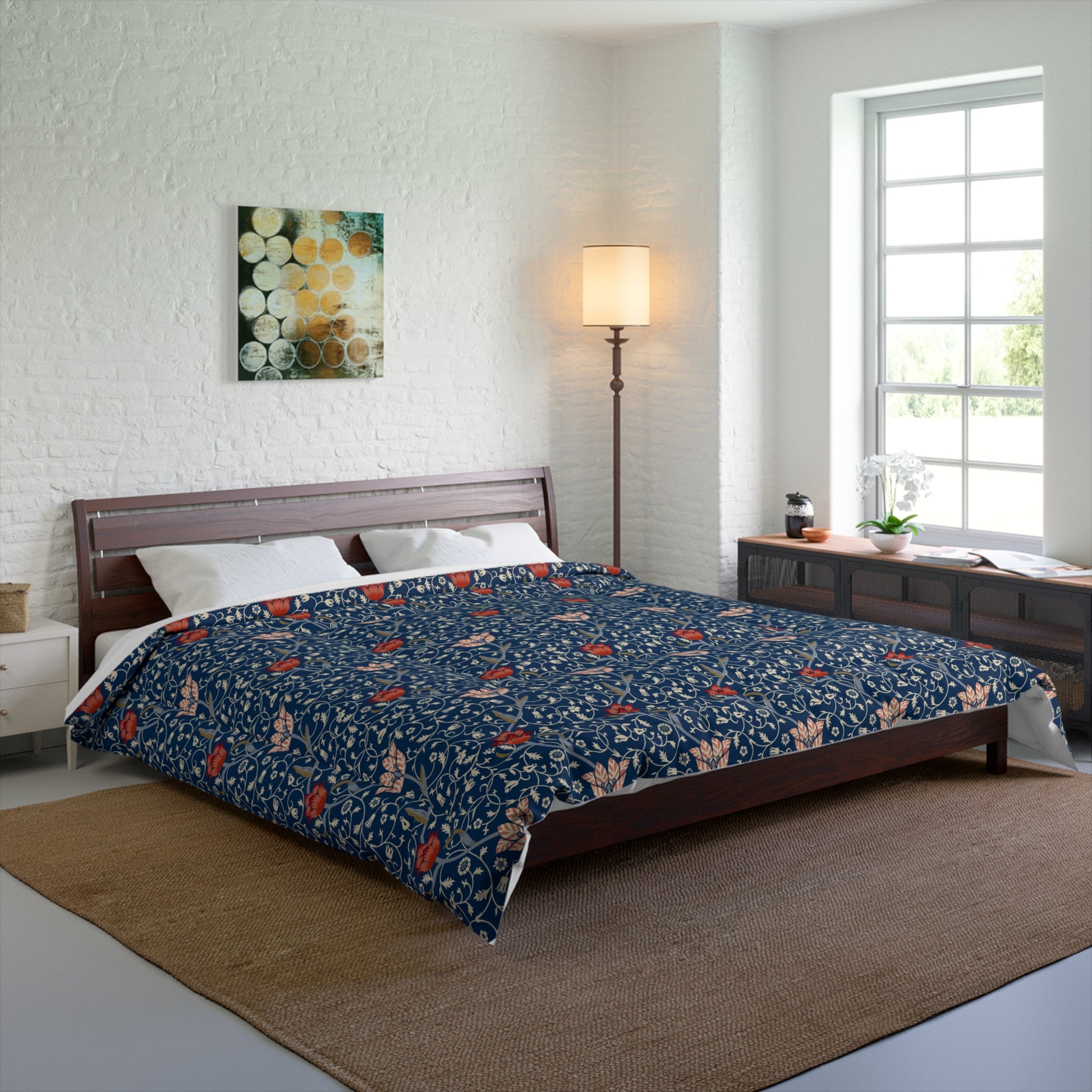 A square-shaped comforter with a blue background featuring a repeating William Morris & Co pattern of red and white apple designs and a plush batting layer visible on one side.