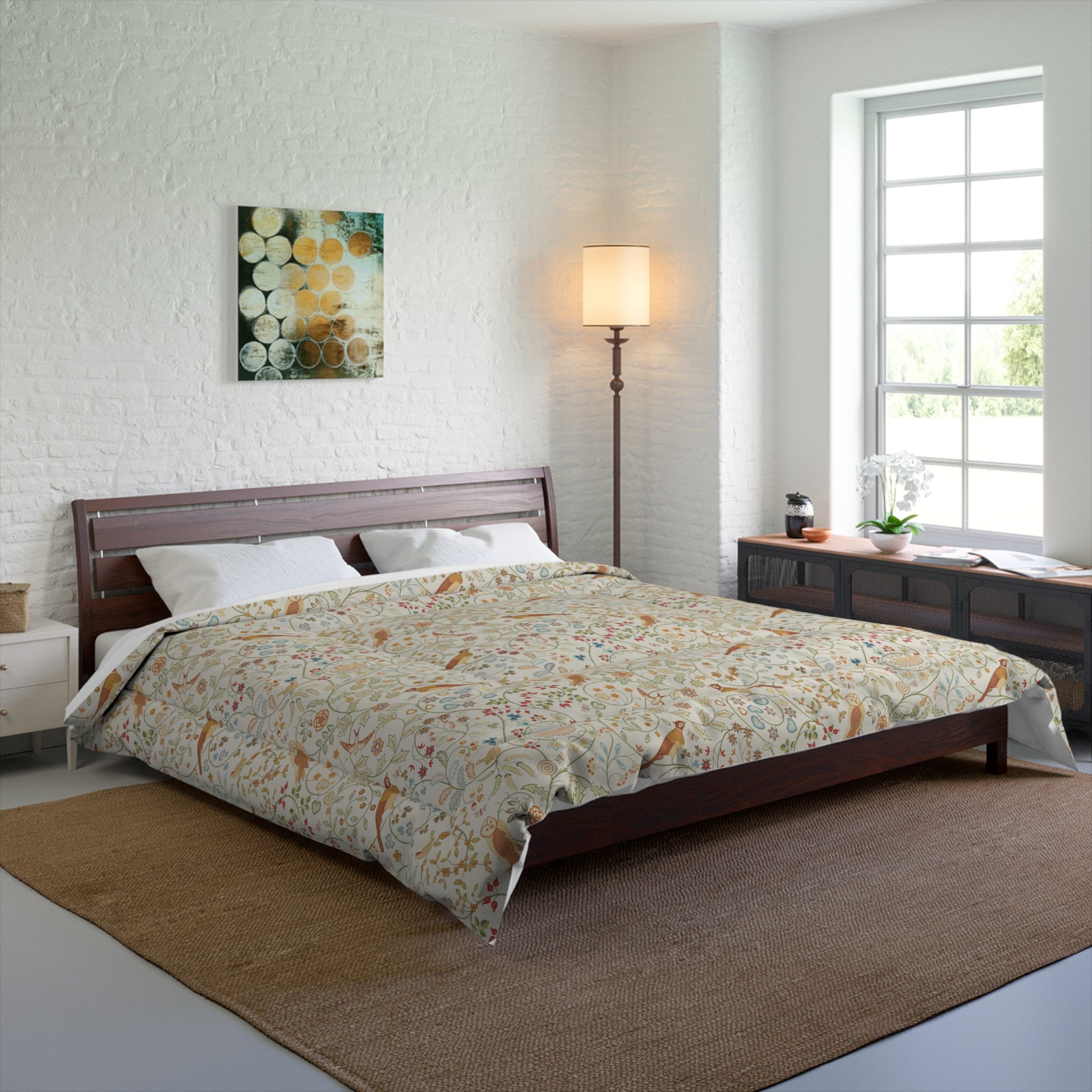 Bedroom with floral comforter on a bed, lamp, and artwork on the wall.