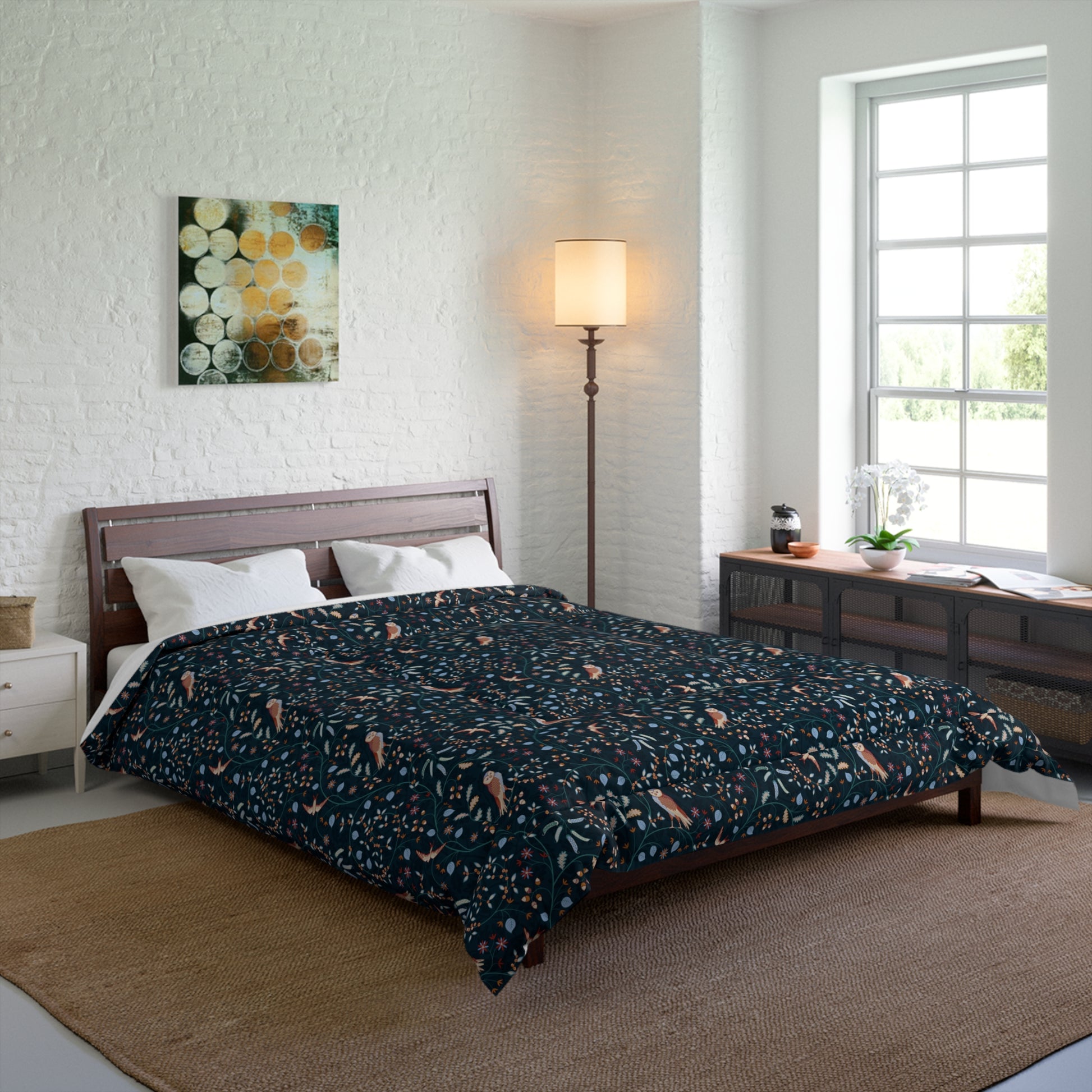 Bedroom with floral comforter on bed, lamp, and artwork on wall.