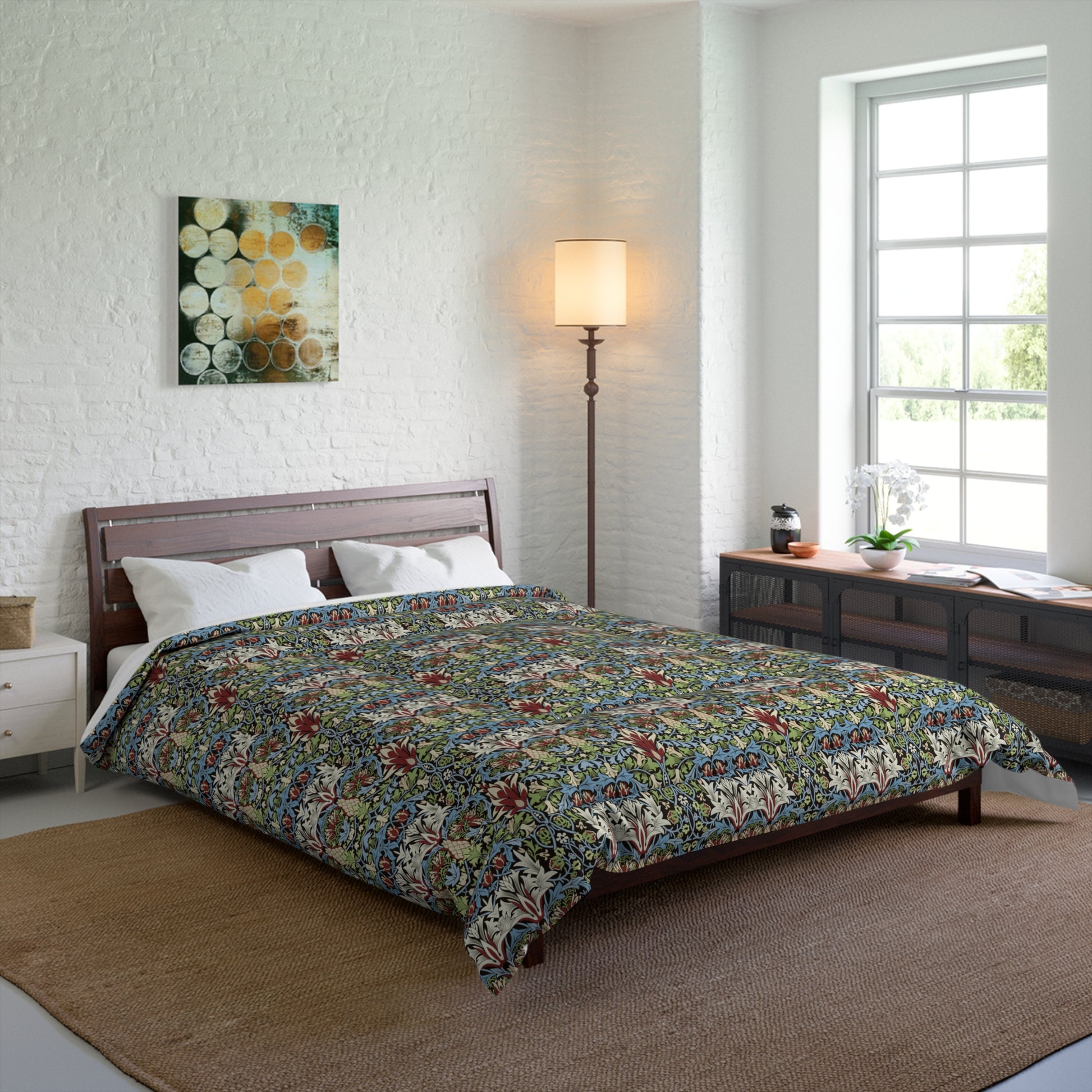 Bedroom with floral comforter on a bed, lamp, and artwork on the wall from William Morris