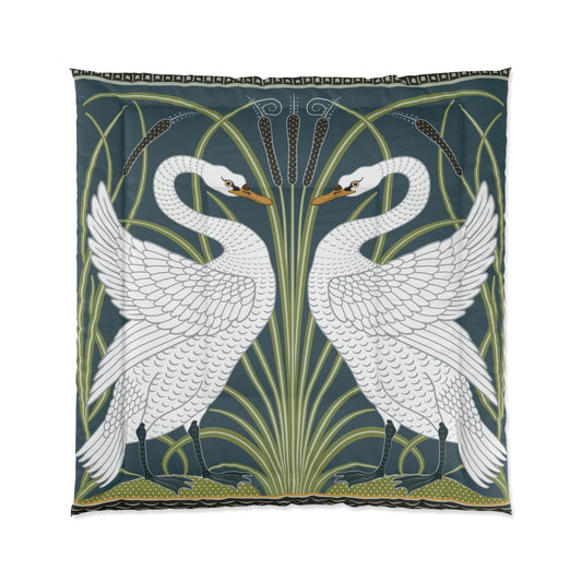 A comforter featuring a double square quilting pattern with a one-sided print of two white swans on a dark green background, surrounded by a floral border in a similar colour palette.