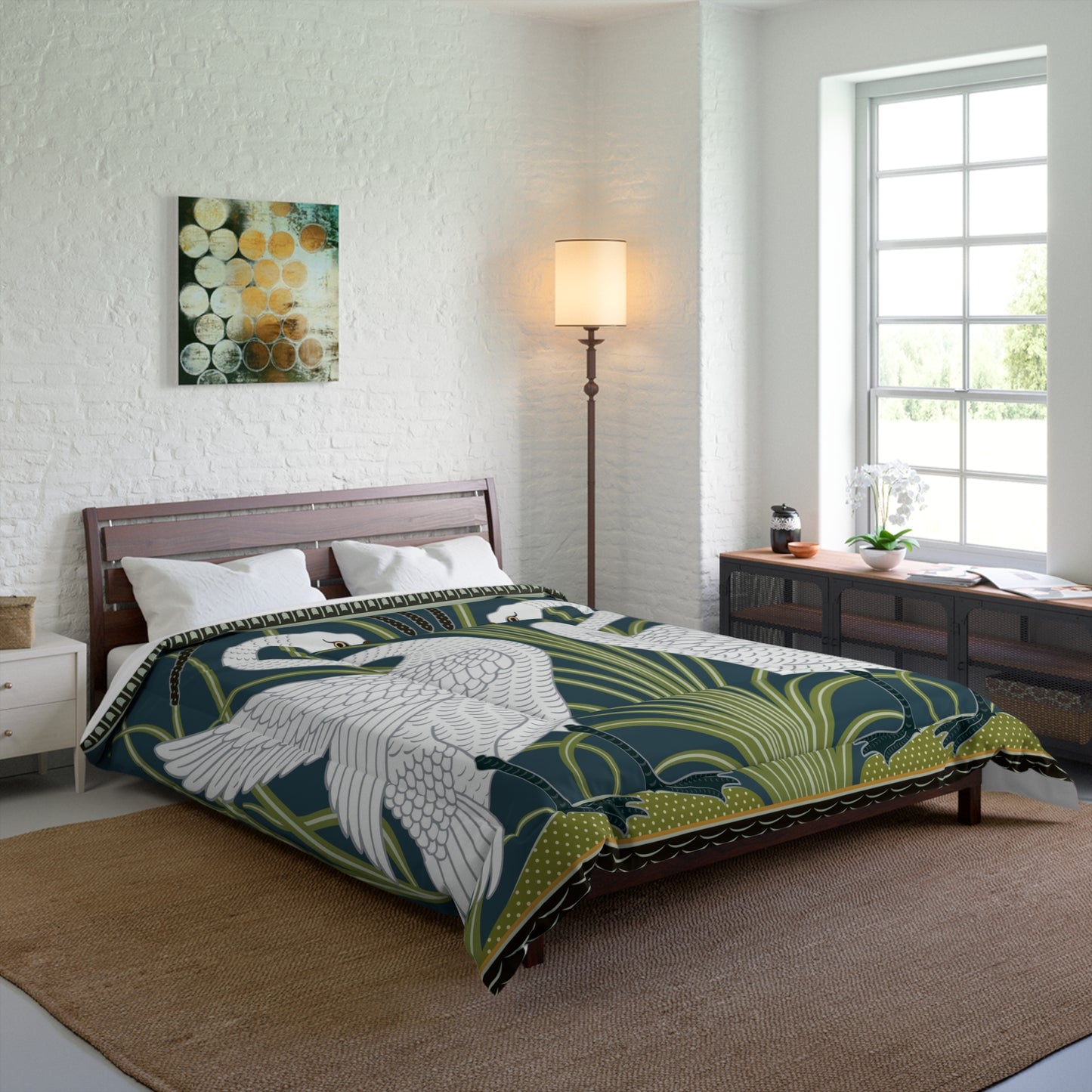 A comforter featuring a double square quilting pattern with a one-sided print of two white swans on a dark green background, surrounded by a floral border in a similar colour palette.