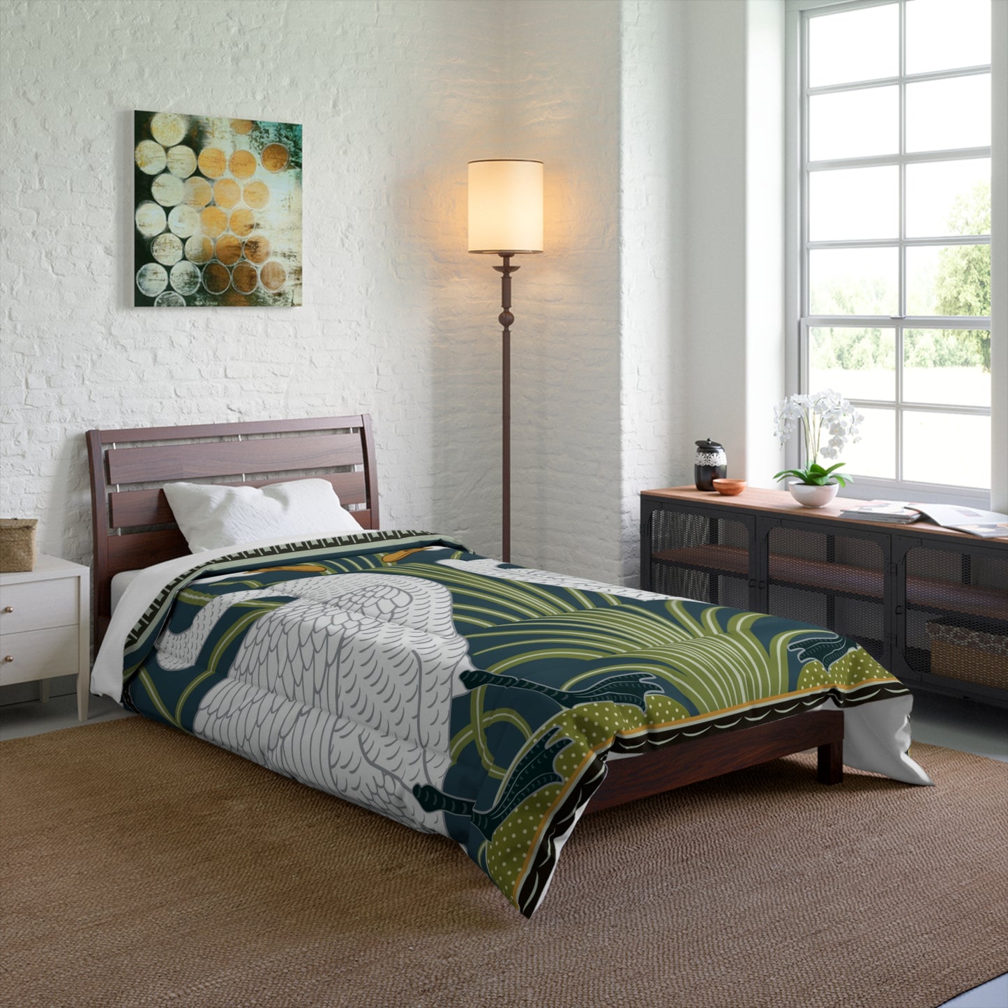 A comforter featuring a double square quilting pattern with a one-sided print of two white swans on a dark green background, surrounded by a floral border in a similar colour palette.