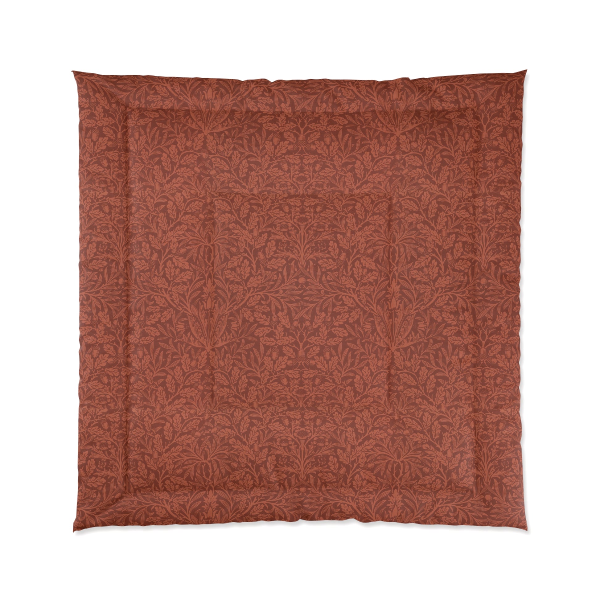 A rectangular comforter with a geometric double square quilting William Morris & Co pattern in a rust colour.