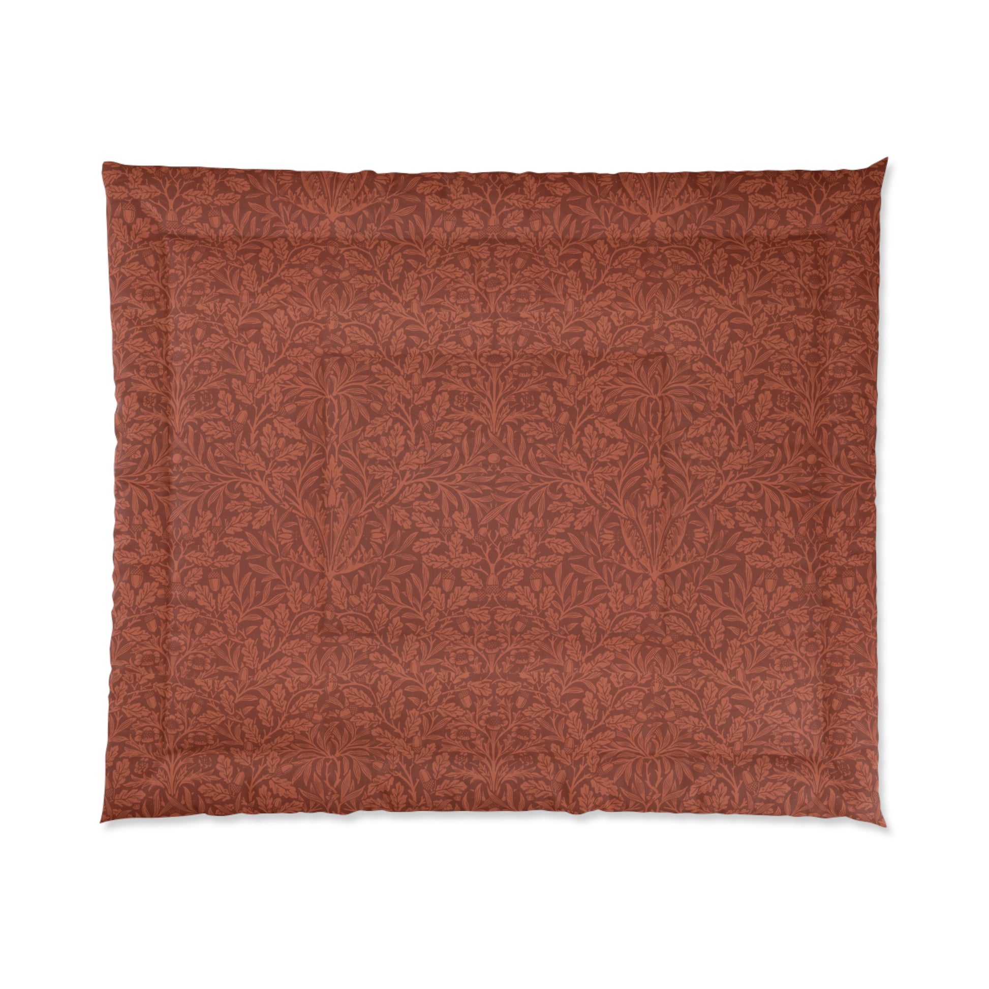 A rectangular comforter with a geometric double square quilting William Morris & Co pattern in a rust colour.