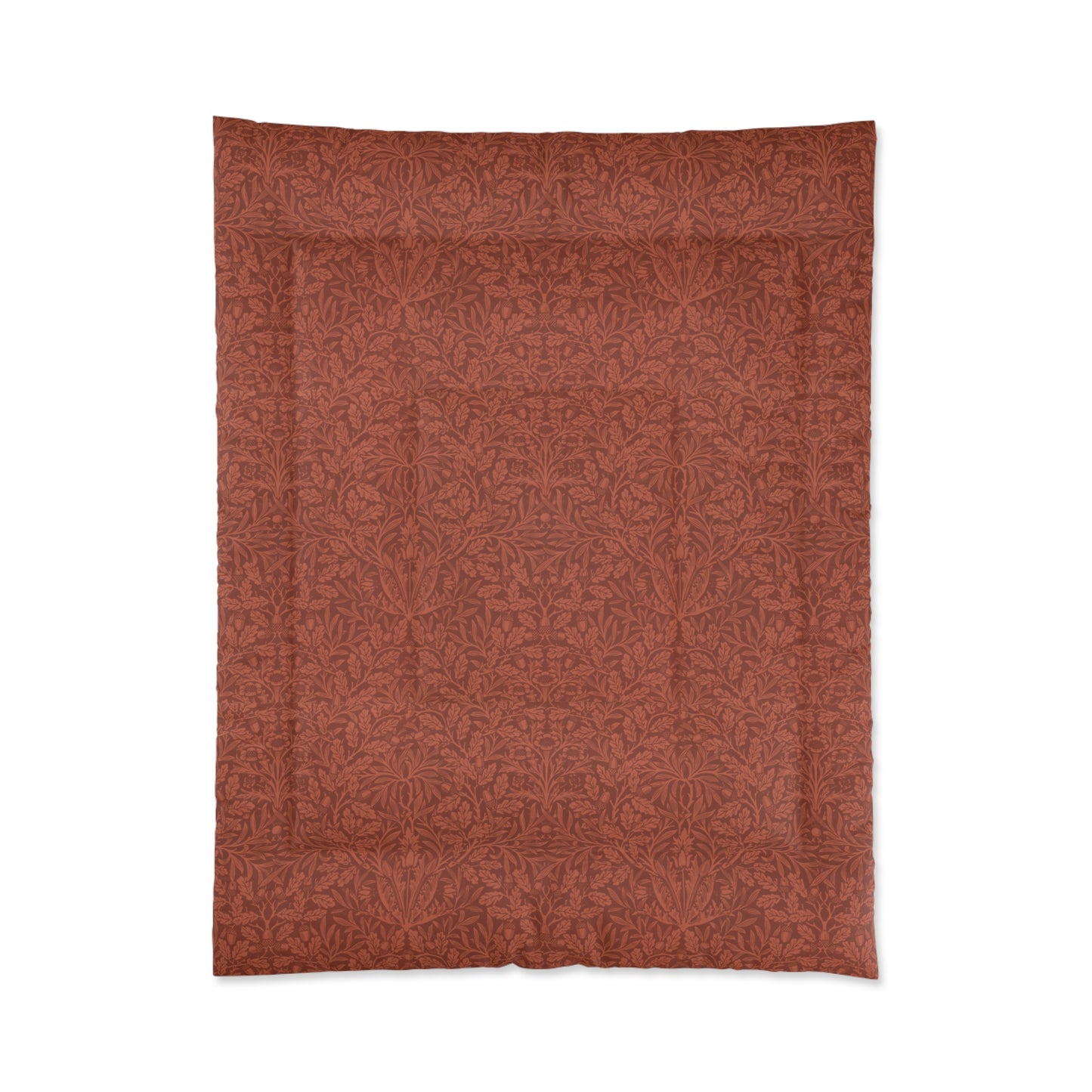A rectangular comforter with a geometric double square quilting William Morris & Co pattern in a rust colour.