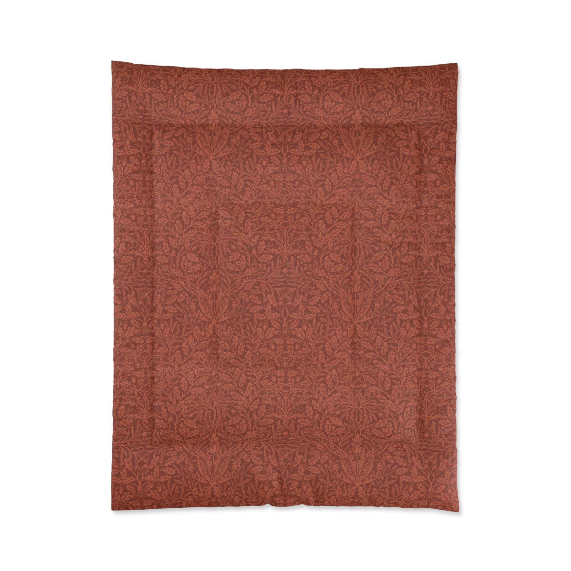 A rectangular comforter with a geometric double square quilting William Morris & Co pattern in a rust colour.