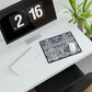 Modern office desk setup with computer, keyboard, mouse, and decorative plant.