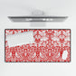 Red and white patterned desk mat with a computer setup on a white background