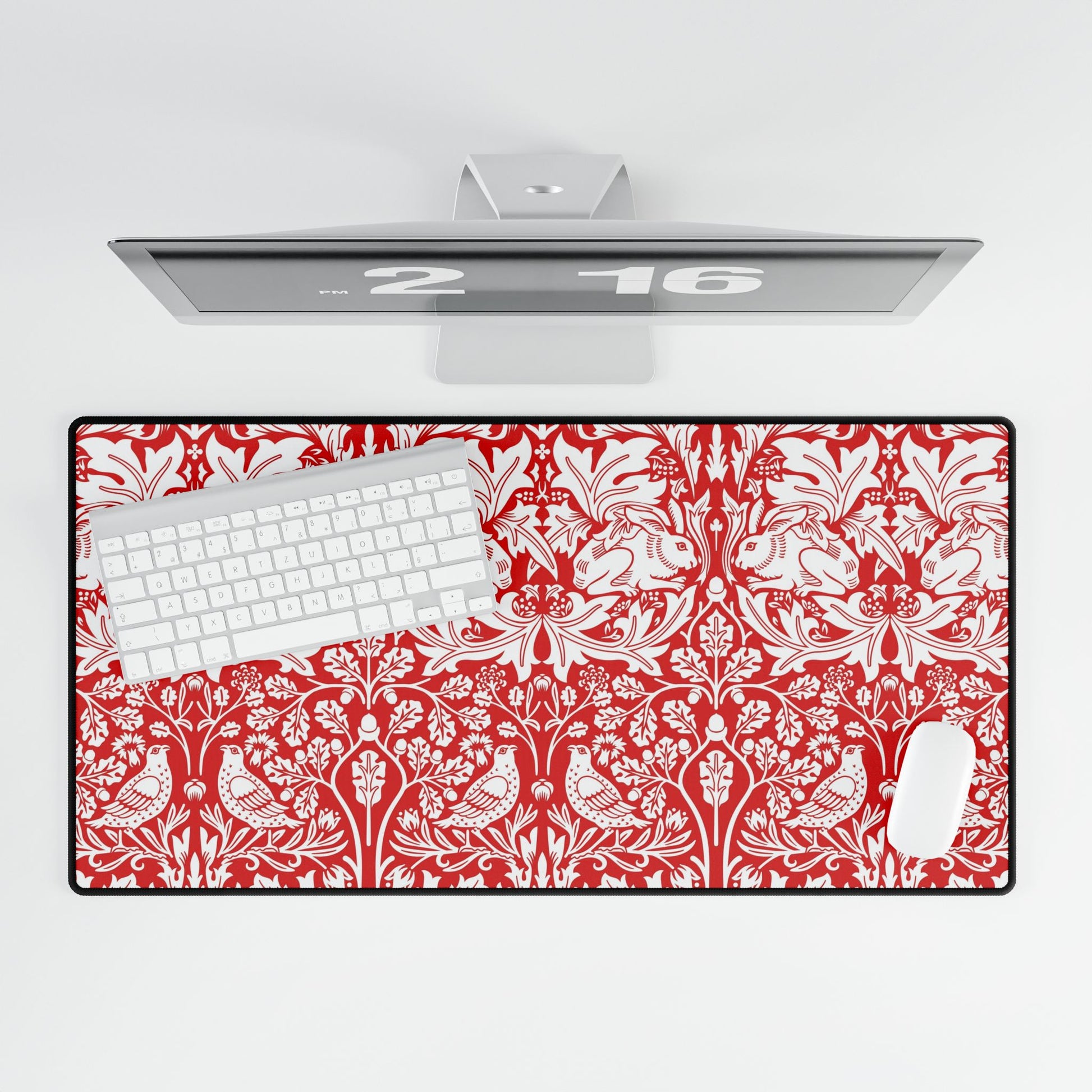 Red and white patterned desk mat with a computer setup on a white background