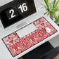 Floral patterned desk mat on a desk with a computer and clock.