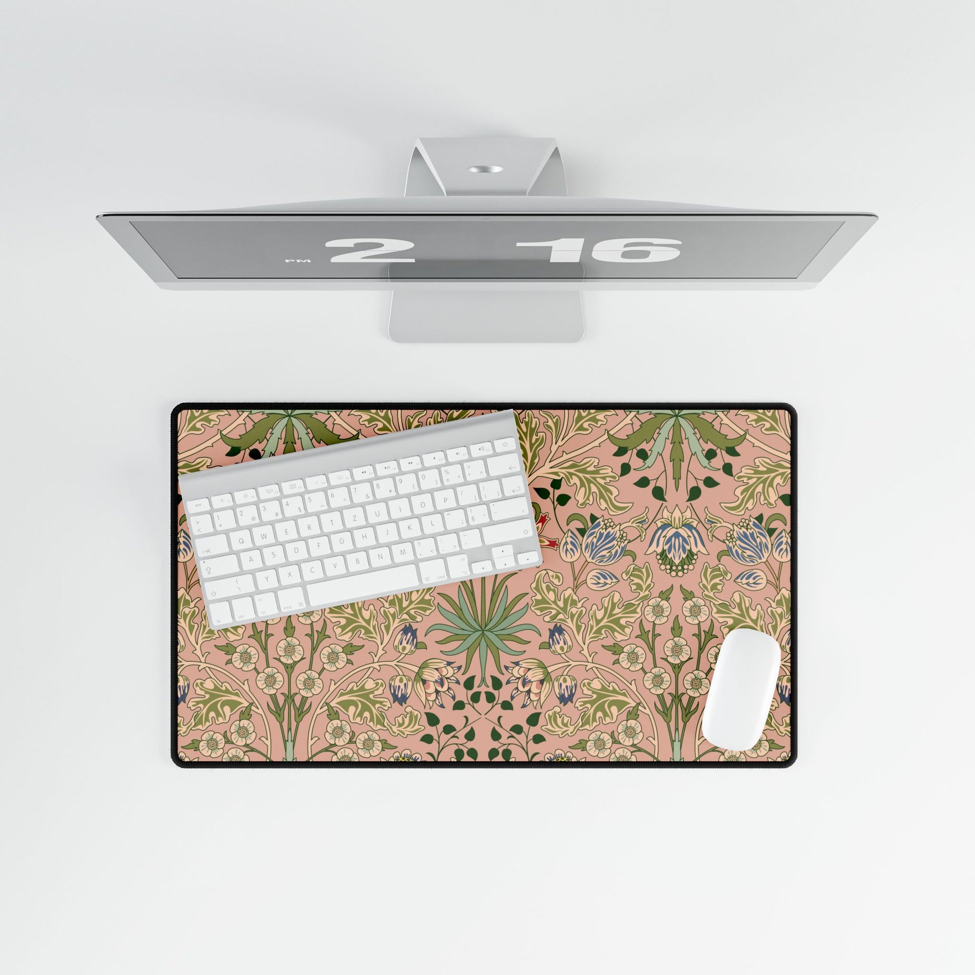Floral desk mat with a computer setup on a white surface