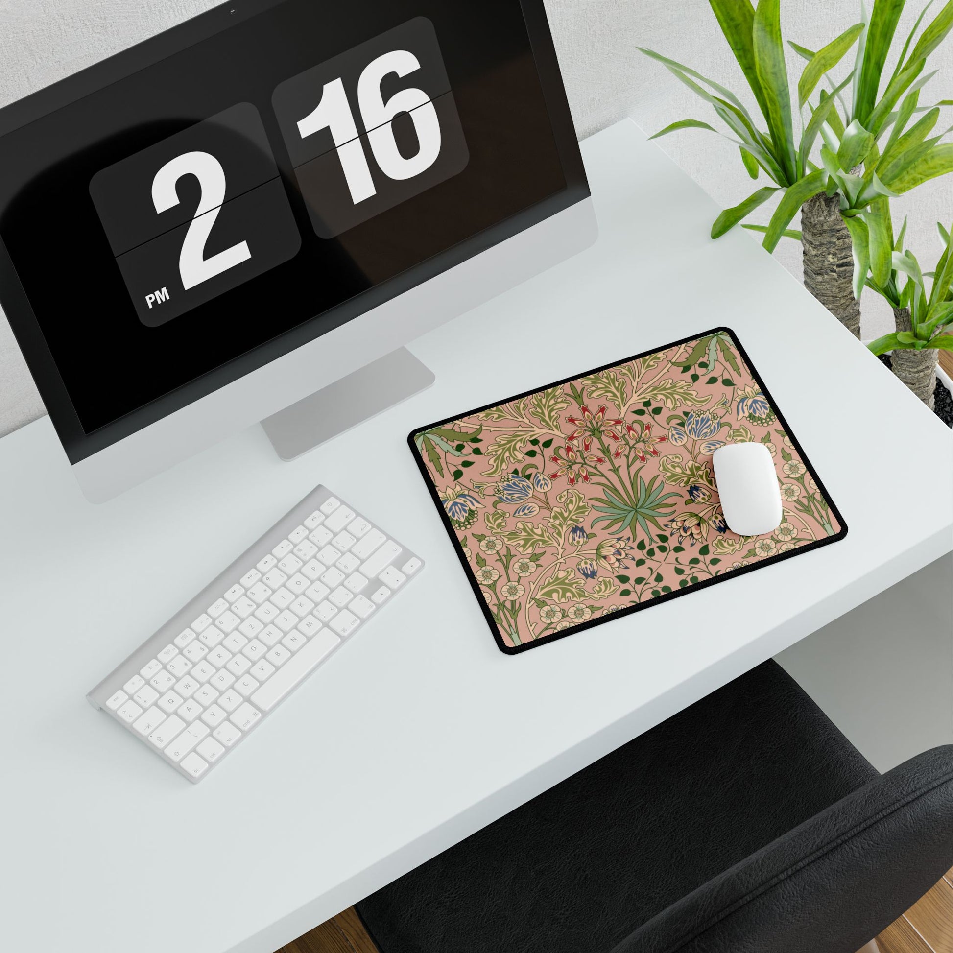 Desk setup with a computer, keyboard, mouse, and decorative mouse pad.