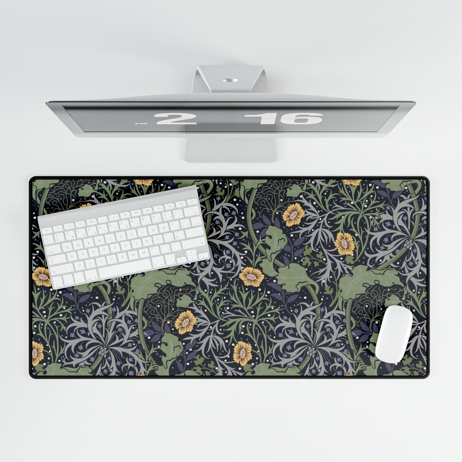 Desk setup with a car-themed mouse pad, keyboard, and computer monitor on a white background.