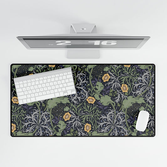 Desk setup with a car-themed mouse pad, keyboard, and computer monitor on a white background.