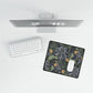 Computer monitor, keyboard, and mouse pad on a white surface