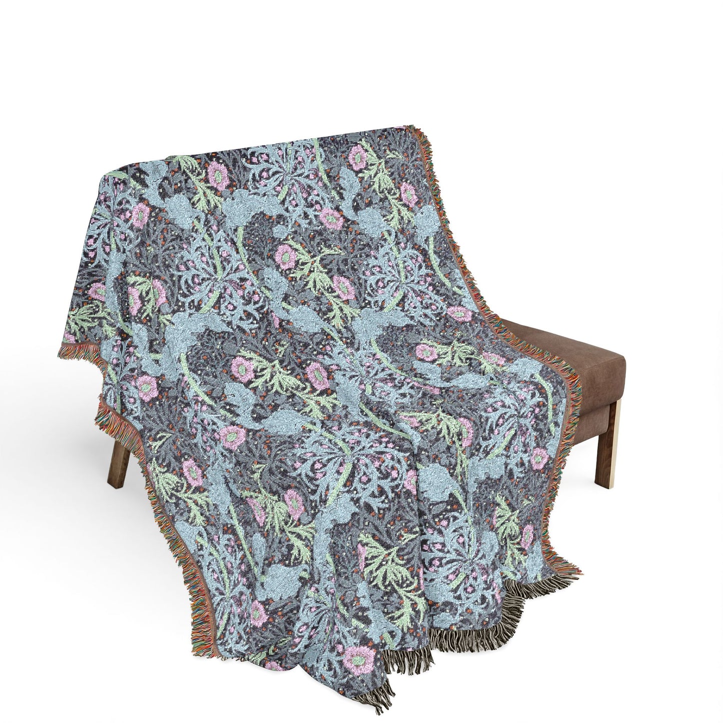 Floral patterned blanket draped over a chair on a white background