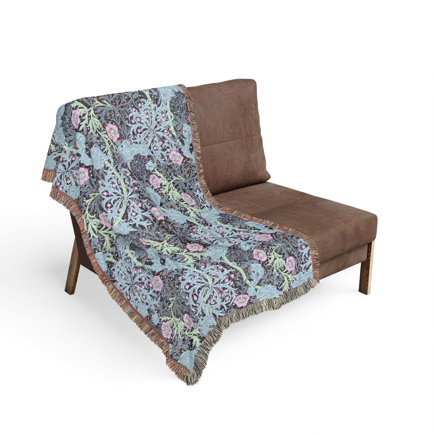 Floral patterned blanket draped over a brown chair on a white background
