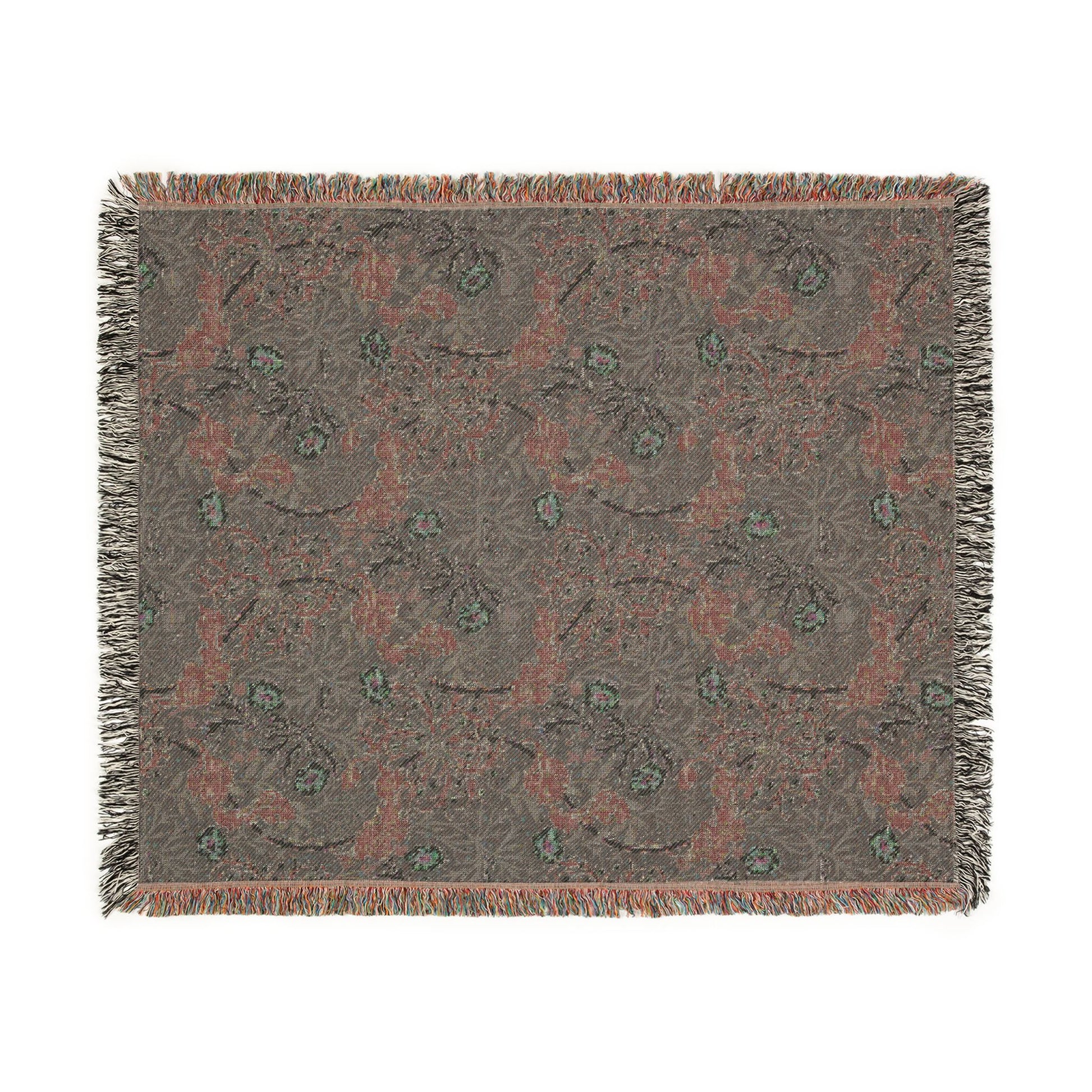 Floral patterned throw blanket with fringe on a white background