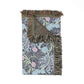 Floral patterned throw blanket with fringes on a white background